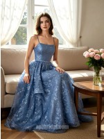 Light Blue Spaghetti Strap Lace Appliqué Layered Asymmetrical Mesh Gown捕捉静谧的色彩美学，这款礼服以浅蓝色调呈现如晨曦般的清透感。上半身覆以精美蕾丝贴花，配合极简细吊带平直领口，勾勒出优雅的肩颈轮廓。裙摆采用独特的层叠不对称网纱设计，在行进间呈现如波浪般的轻盈动态。二十年匠心工艺确保了网纱的支撑力与亲肤感，是高端舞会、婚礼伴娘或正式庆典的理想之选。